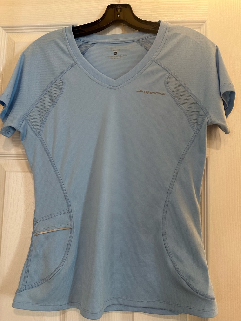 Brooks Women's Pale Blue V-Neck Running Tee. With front reflectors.